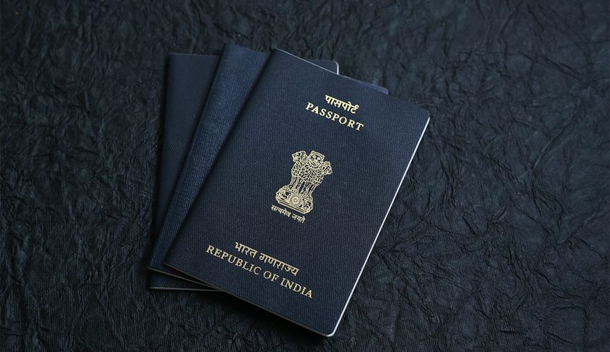 Indian Passport and currency note for making foreign travel or world tour budget plan.
